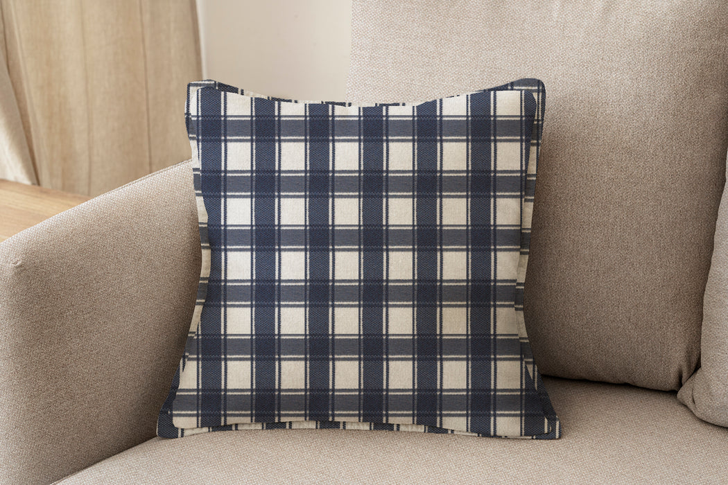 Decorative pillow upholstered in Revolution Performance Fabric Denmark Indigo, featuring a deep navy plaid pattern with layered vertical and horizontal bands that create a classic, tailored aesthetic. The performance construction makes it ideal for everyday family-friendly living.