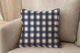 Decorative pillow upholstered in Revolution Performance Fabric Denmark Indigo, featuring a deep navy plaid pattern with layered vertical and horizontal bands that create a classic, tailored aesthetic. The performance construction makes it ideal for everyday family-friendly living.