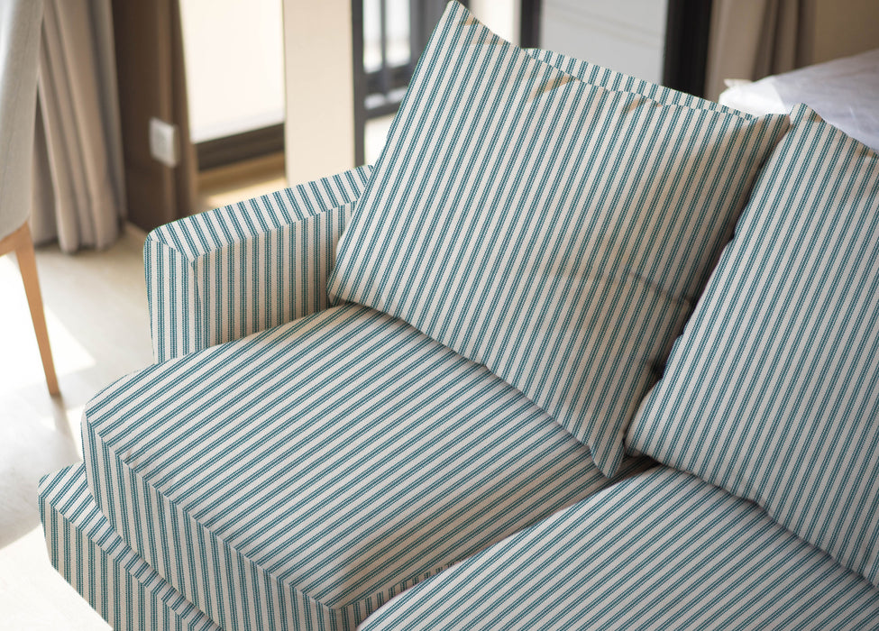 Upholstered sofa shown in Revolution Performance Fabric Foreshore Bottle, featuring deep teal and soft cream vertical stripes that create a clean, tailored look. The smooth, finely woven texture highlights the subtle contrast between the stripe bands.