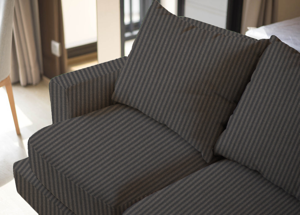 Upholstered sofa shown in Revolution Performance Fabric Foreshore Carbon, featuring dark charcoal and soft grey vertical stripes that create a clean, tailored look. The smooth, finely woven texture highlights the subtle contrast between the stripe bands.