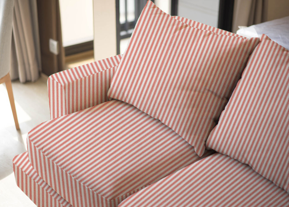 Upholstered sofa shown in Revolution Performance Fabric Foreshore Mango, featuring warm mango-orange and ivory vertical stripes that create a clean, tailored look. The smooth, finely woven texture highlights the subtle contrast between the stripe bands.