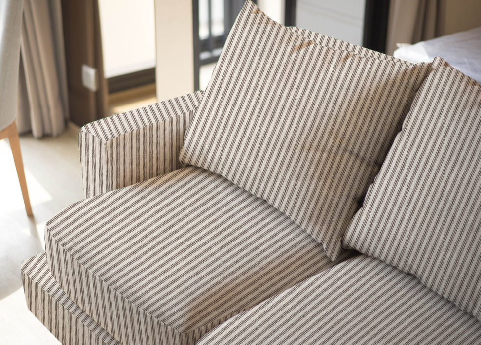 Upholstered sofa shown in Revolution Performance Fabric Foreshore Walnut, featuring warm brown and ivory vertical stripes that create a clean, tailored look. The smooth, finely woven texture highlights the subtle contrast between the stripe bands.