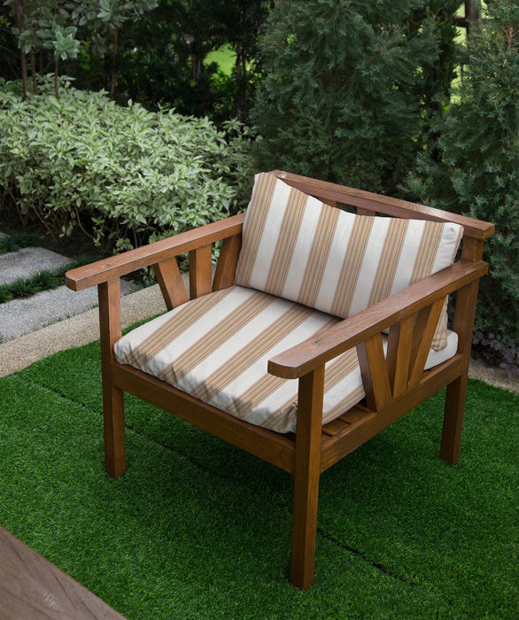 Lifestyle image of Revolution Performance Upholstery Fabric, pattern Gracias in Summer, shown upholstered on an outdoor lounge chair. Narrow vertical stripes in warm coral, golden yellow, soft green, and neutral tones frame an ivory woven center panel, creating a crisp, tailored stripe with subtle texture and a lively, sun-washed look.