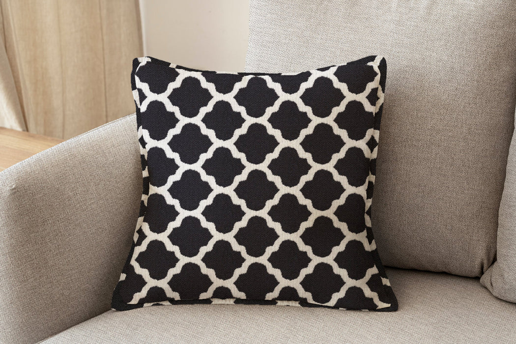 Revolution Performance Fabric accent pillow in the Metalwork pattern, Onyx colorway, showcasing a bold black and ivory geometric trellis design woven for high-performance upholstery and refined interior styling.