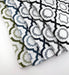 Assorted Revolution Performance Fabric swatches in the Savannah pattern arranged in a fanned layout, showcasing green, navy, blue, grey, and black geometric lattice designs woven over an ivory base for durable, high-performance upholstery applications.