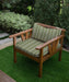 Lifestyle image of Revolution Performance Upholstery Fabric, pattern Starboard in Grass, shown upholstered on an outdoor lounge chair. The woven vertical stripe design features fresh grass green tones paired with crisp ivory stripes, creating a clean, coastal look with subtle texture and relaxed visual rhythm.